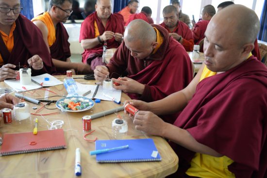 Buddhist monks engage in science experiments in Bhutan. Photo by Bryce Johnson