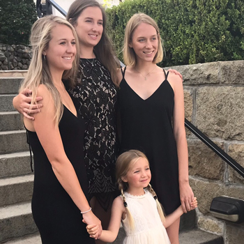 Philip Barlow's four daughters hold hands and smile