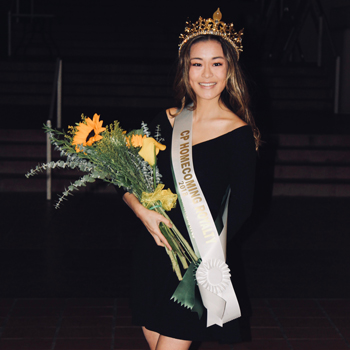 Hannah Simons holding a bouquet and wearing a Cal Poly Homecoming Royalty sash