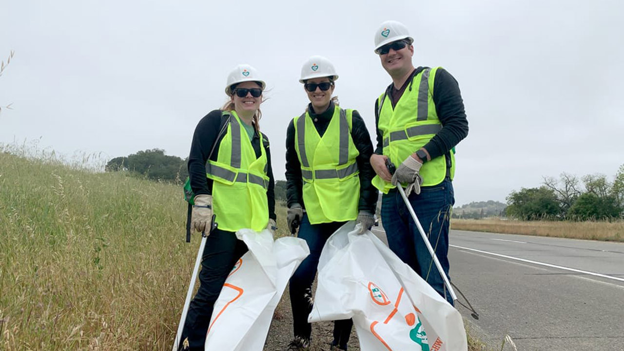 Three members of Cal Poly's North Bay Chapter clean up a stretch of Highway 101