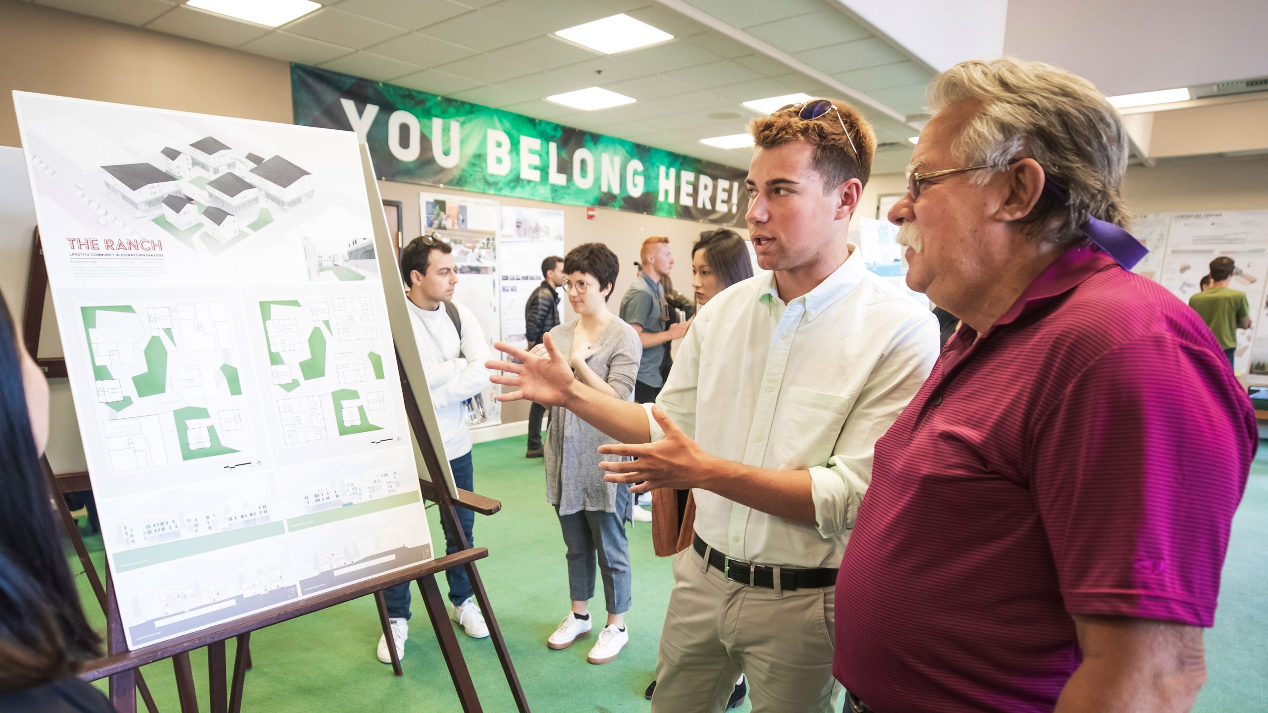 Architecture student Foster Westover shares his building concept with alumnus and architect Glenn Bruno in Paradise. Photo by Joe Johnston.