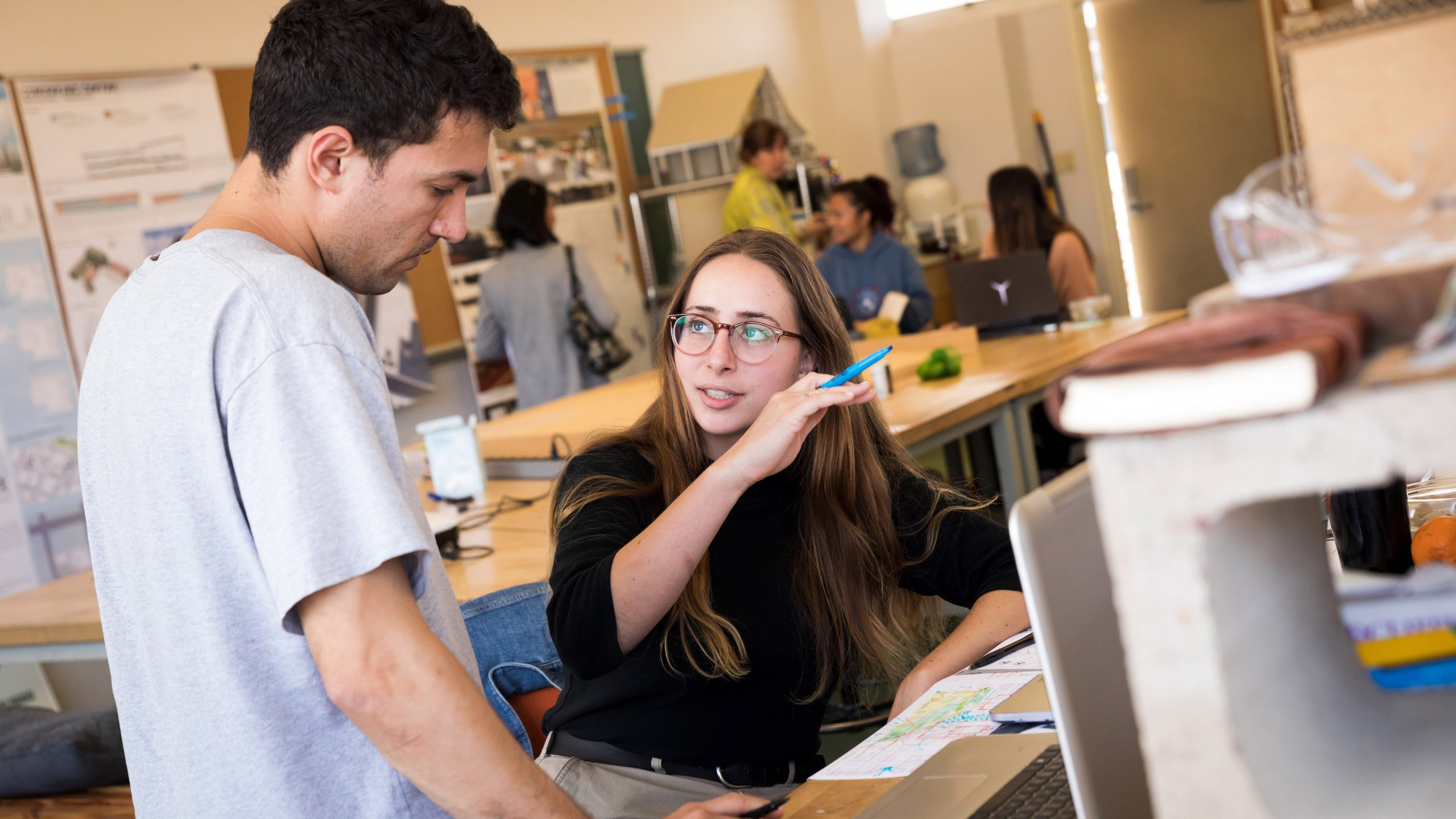 Katherine Young and Nathan Chudnovsky look over their design in the Cal Poly architecture studio. Photo by Joe Johnston.