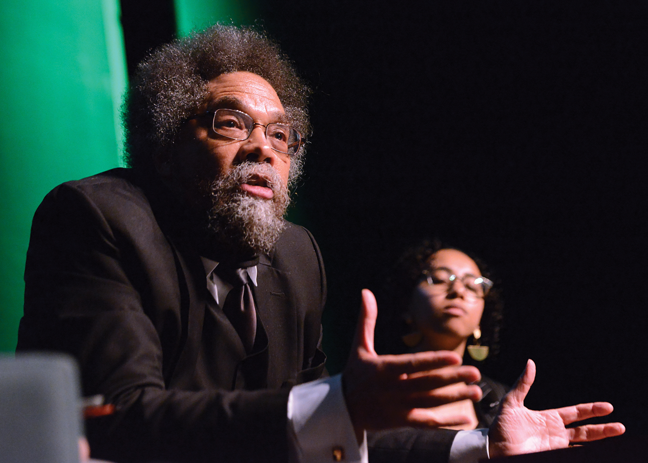 Dr. Cornel West speaks on stage at the Performing Art Center pavillion with student Leilani Hemmings Pallay