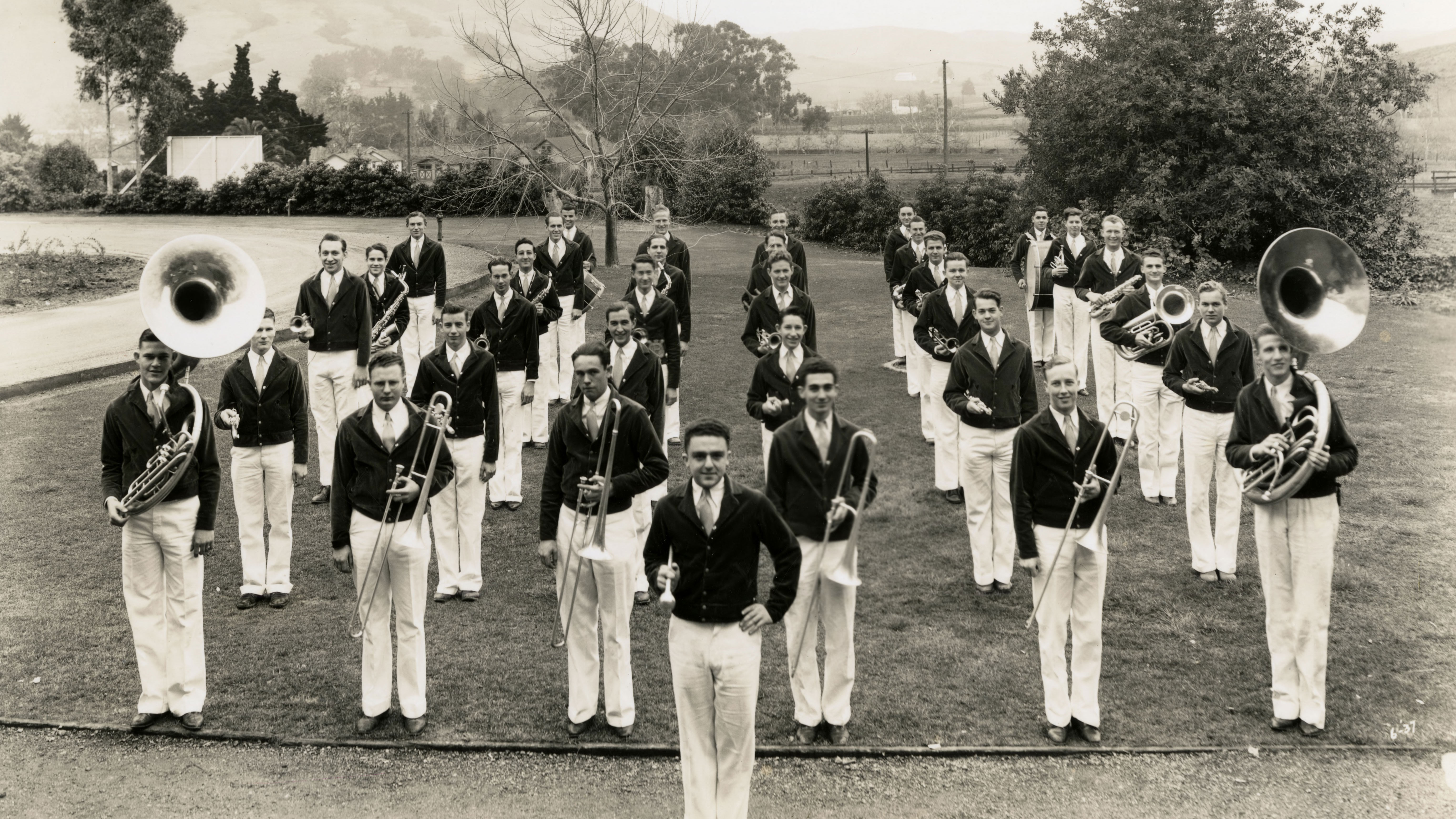 A black and white photo of the all-male marching band in 1937 in formation on the Cal Poly track.