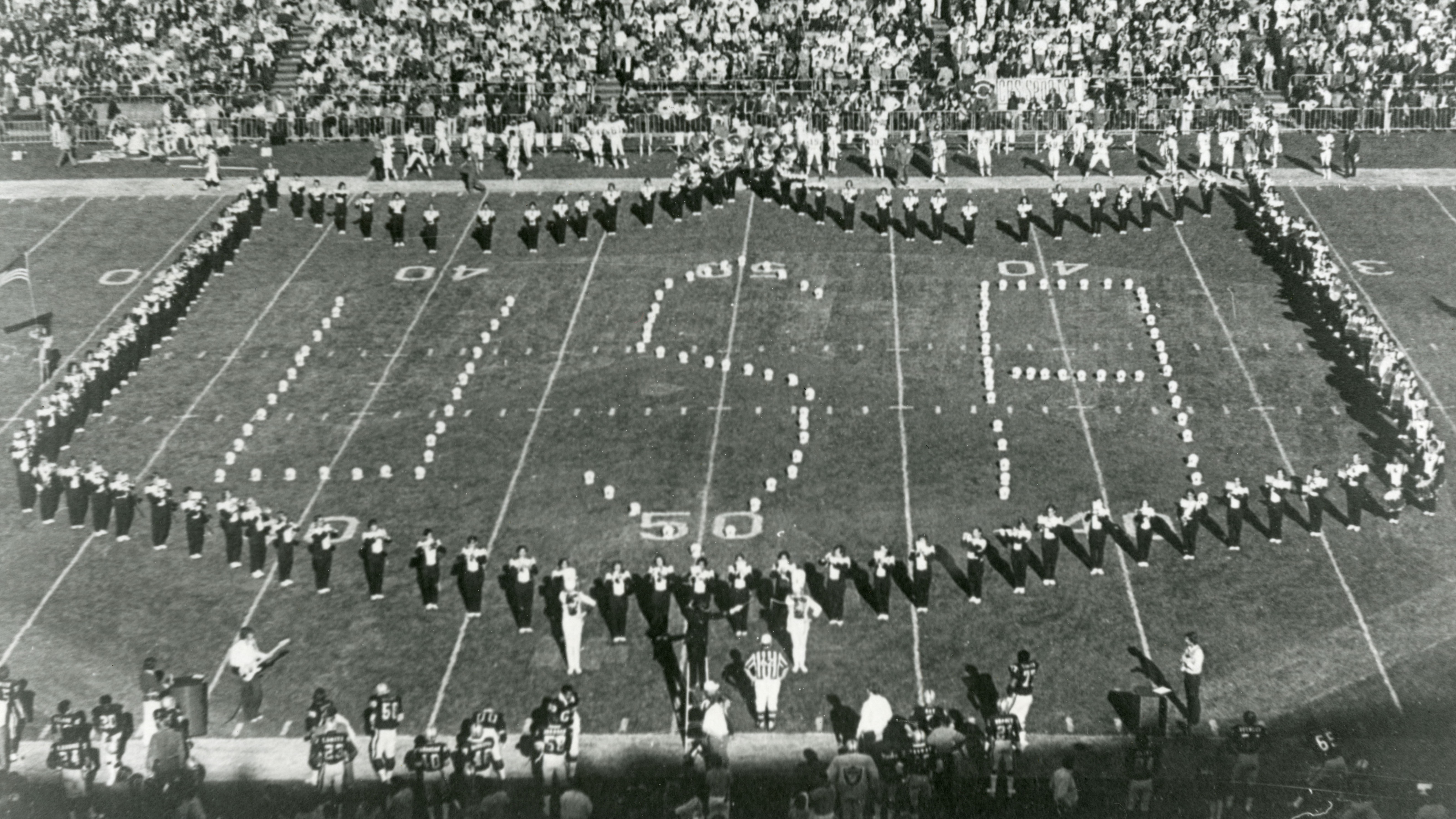 Cal Poly's marching band spells out 'USA' on the field of an NFL game in the 1970s