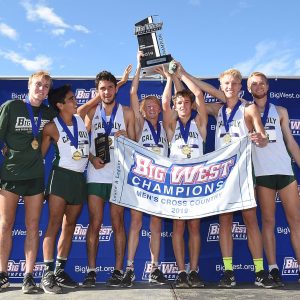 The Cal Poly men's cross country team holds their Big West Championship trophy above their heads