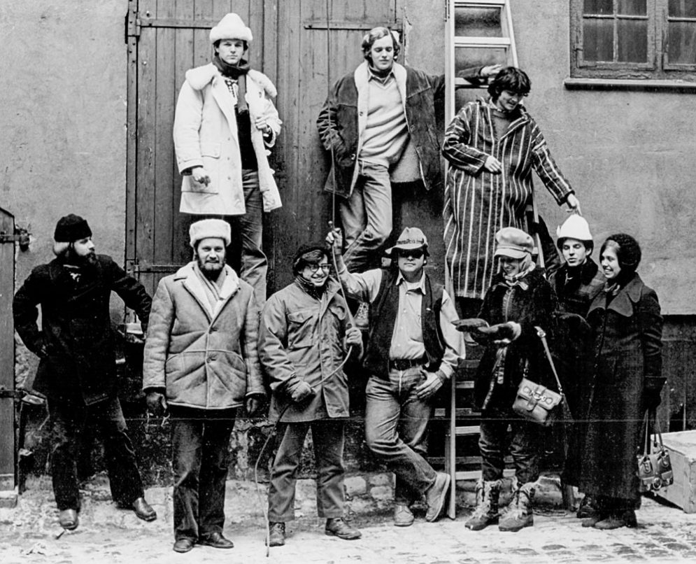A black and white image of group of ten people standing in winter coats
