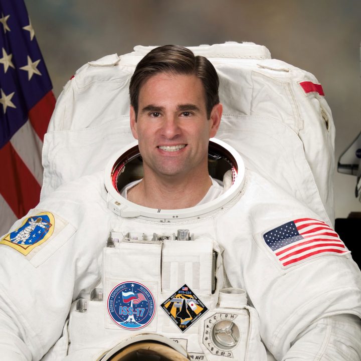 Astronaut Greg Chamitoff smiles in his space suit