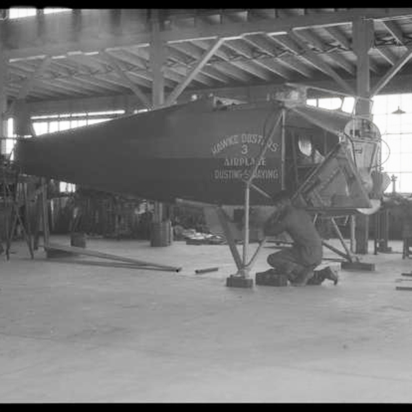 People work on the body of an aircraft in the Cal Poly aeronautics hanger