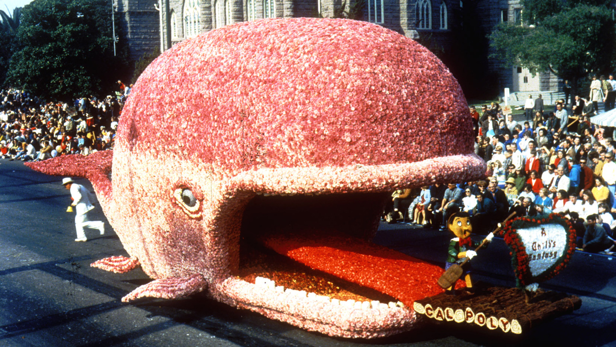 A rose covered float depicting Pinocchio and the whale