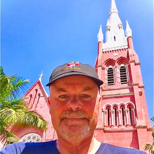 Jim McMorran stands in front of a tall brick structure