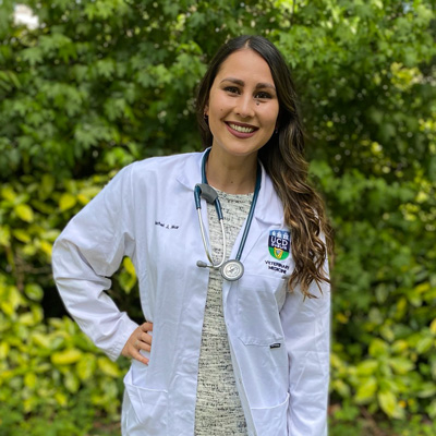 Rachel Mar wears a white coat and stethoscope