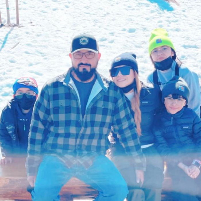 Eric Hernandez stands in the snow with a woman and three children