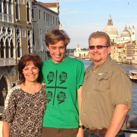 Frank Marinelli stands on a bridge with a young man and a woman