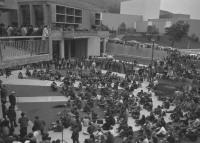 A black-and-white archive photo of students gathered in the University Union. 