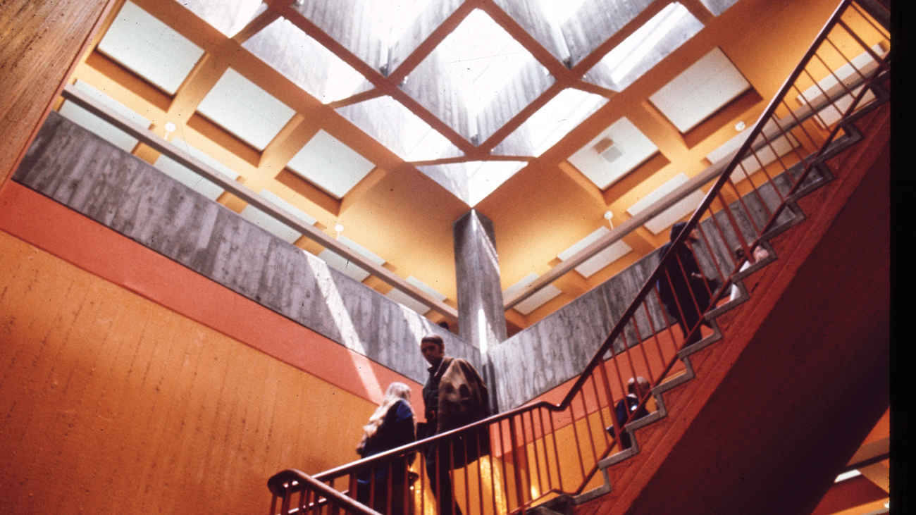 Three people descend the staircase at the University Union