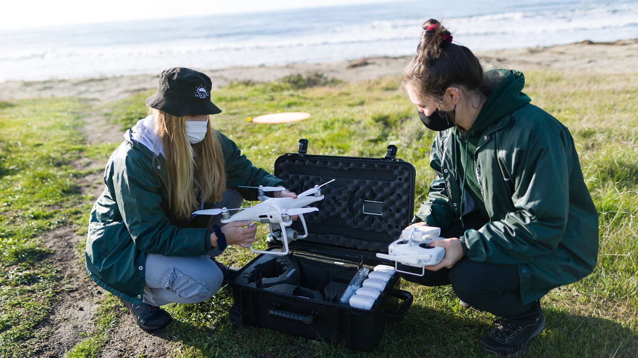 Graduate students Kate Riordan and Molly Murphy prepare a drone for flight at one of the beaches near San Simeon. NMFS permit #22187-02