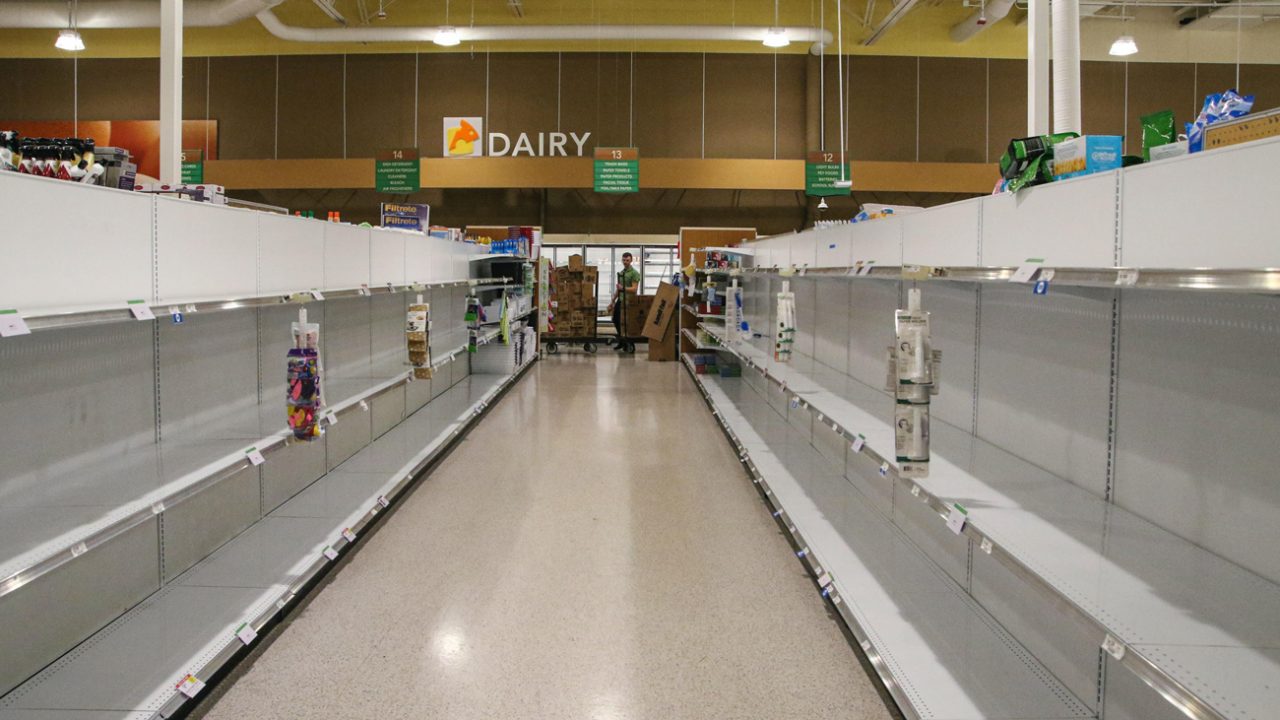 An aisle of empty shelves at a grocery store
