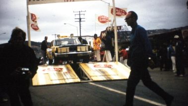 The baja taxi crosses a finishline under a 'Baja 500' banner in 1972