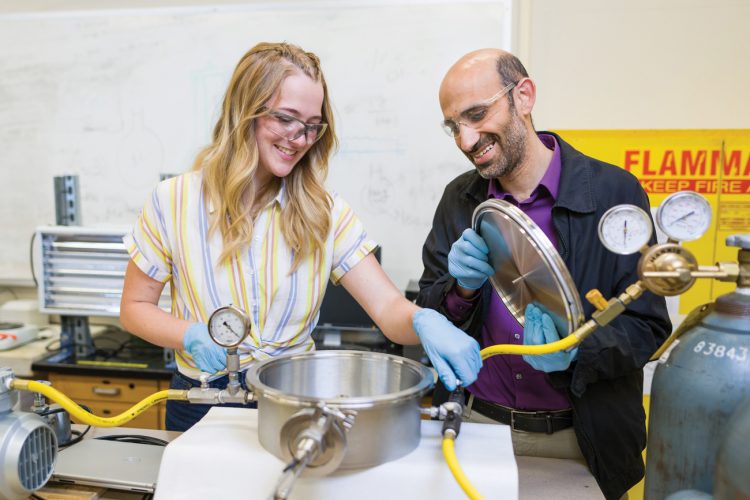Civil engineering student Corinne Watson and Professor Amro El Badawy work with equipment in a Cal Poly lab