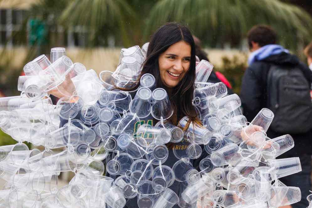 A student is covered in clear plastic cups