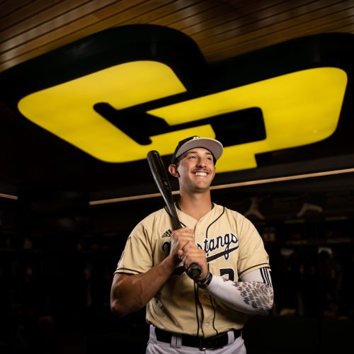 Brooks Lee holds a bat under the CP logo