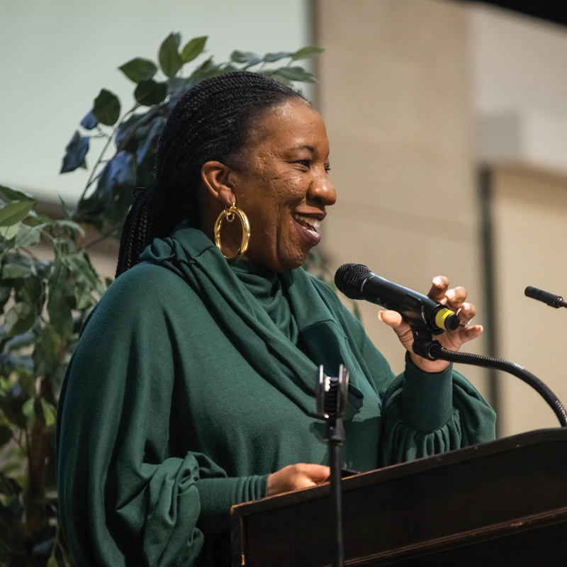 Tarana Burke speaks at a podium at Cal Poly