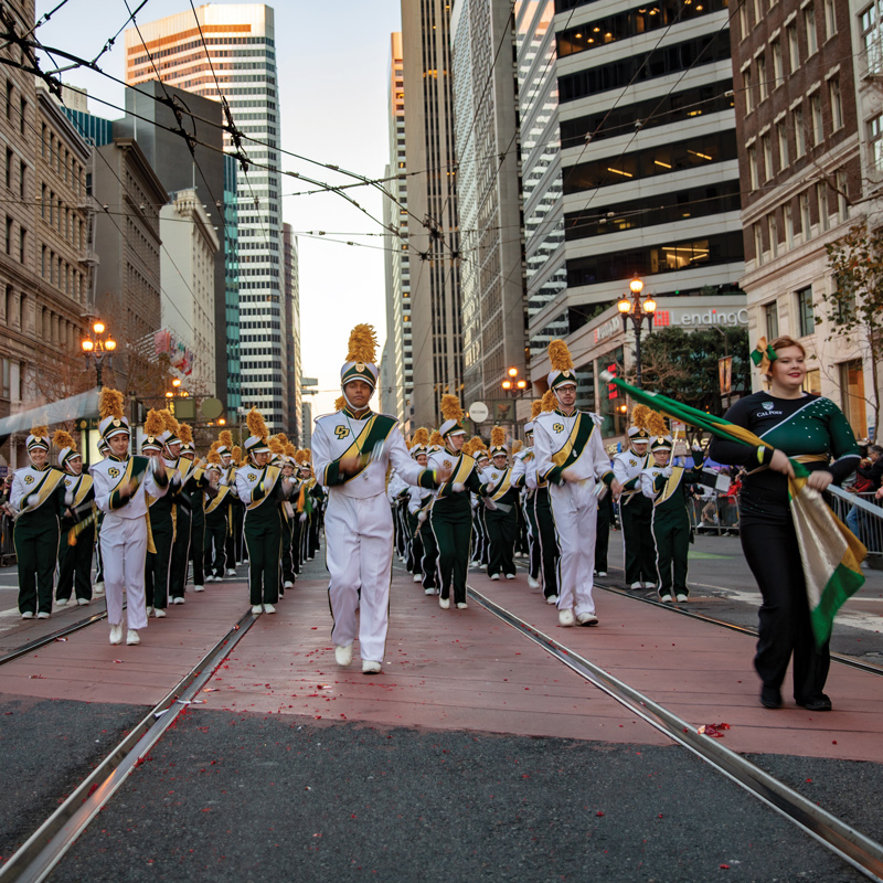 The Mustang Band and Colorguard perform march in formation on the streets of San Francisco