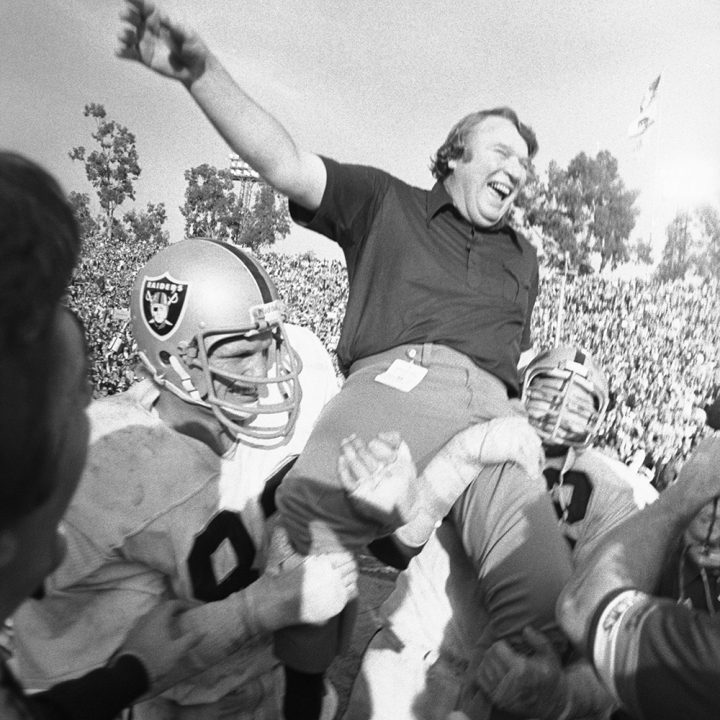 Raiders players hoist Madden into the air following their Super Bowl victory