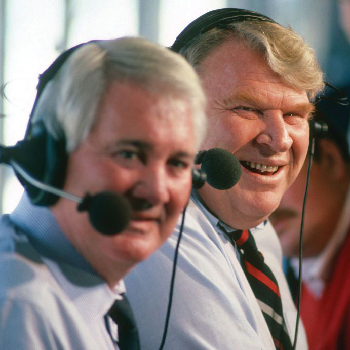 Madden sits in a broadcast booth with partner Pat Summerall