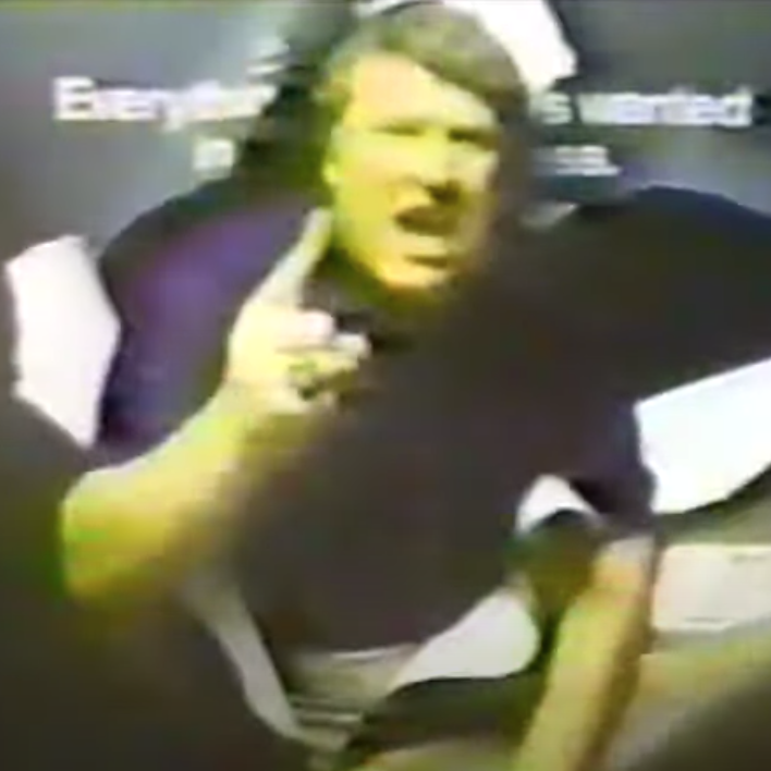 Madden bursts through a title card in a scene from a 1981 Miller Lite commercial