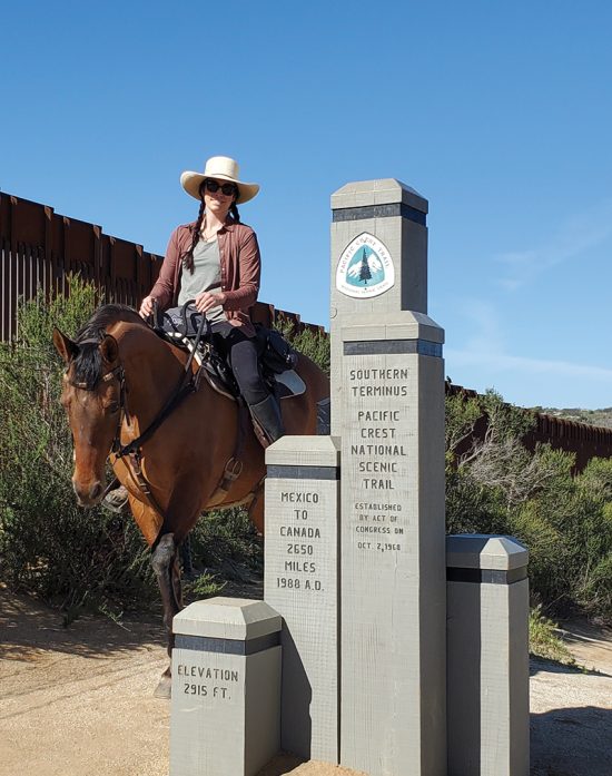 Woman on horseback at the end of the Pacific Coast Trail