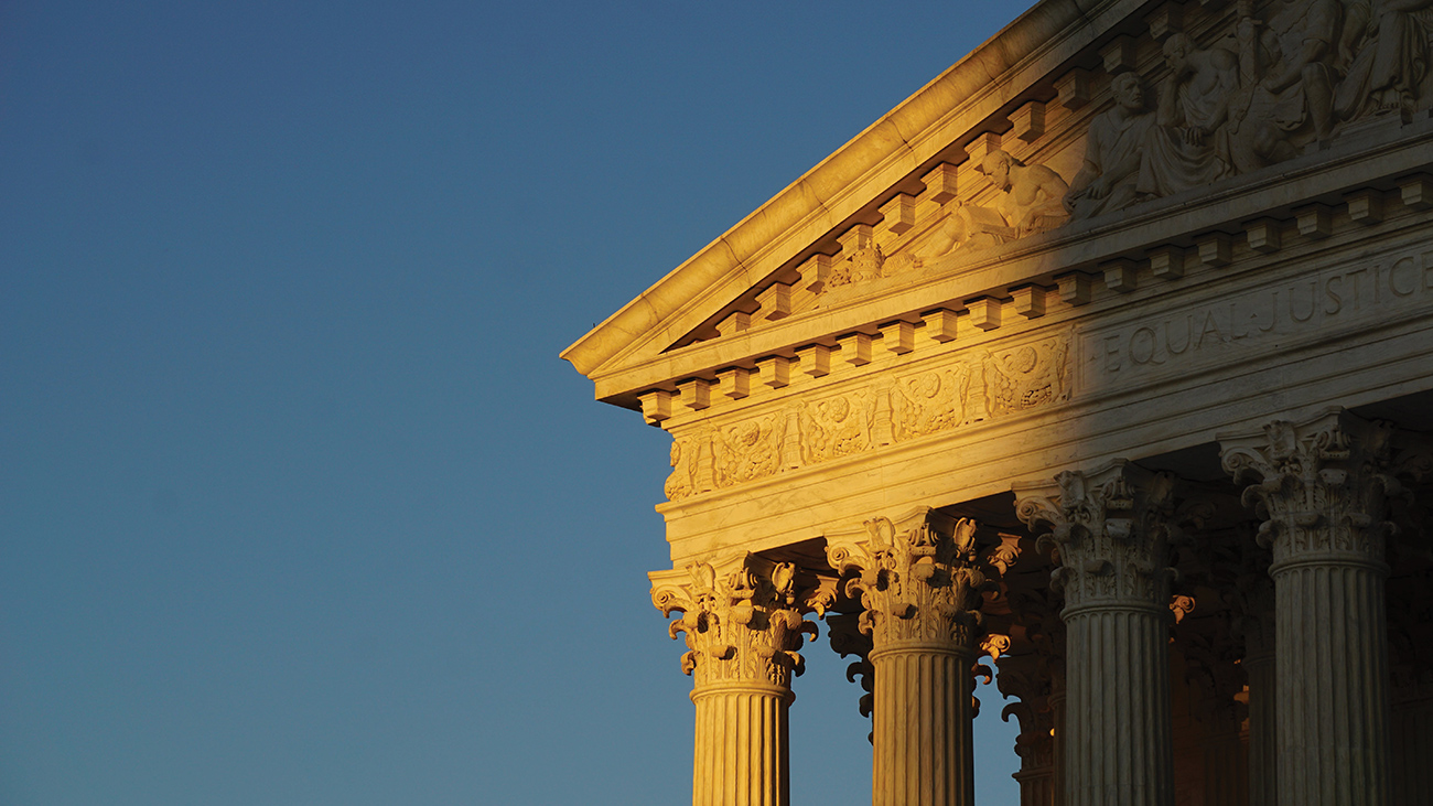 Classical building detail against a blue sky