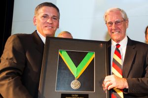 President Jeffrey Armstrong and President Emeritus Warren Baker smile while holding a framed medal
