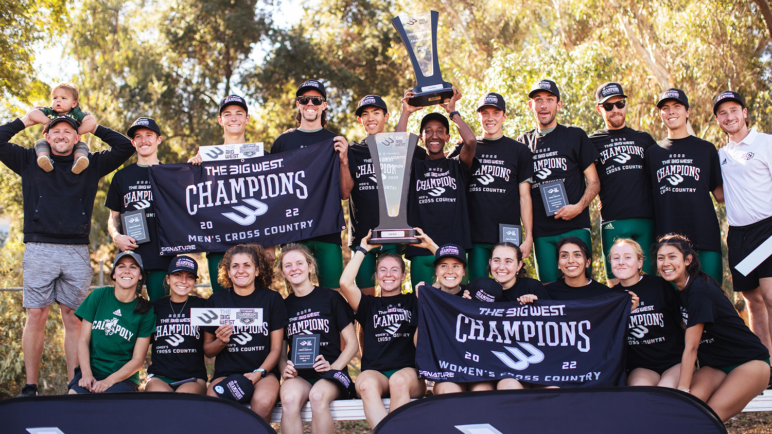 The men's and women's cross country teams wear black shirts and hoist conference championship trophies and banners