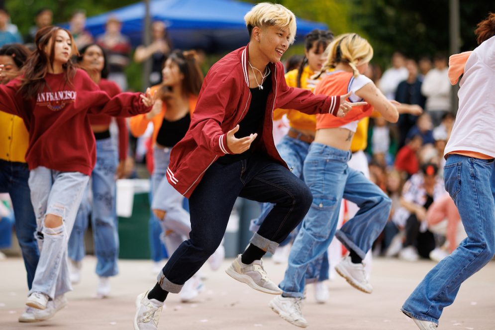 Student performers dance in red jackets during the annual Culturefest celebration
