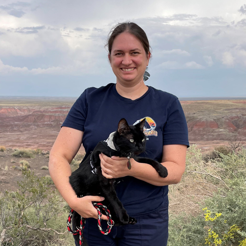 Emily Segal holds a black cat