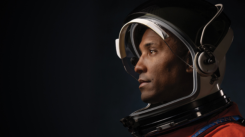 Astronaut Victor Glover in his orange space suit and helmet