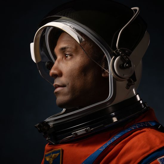 Astronaut Victor Glover in his orange space suit and helmet