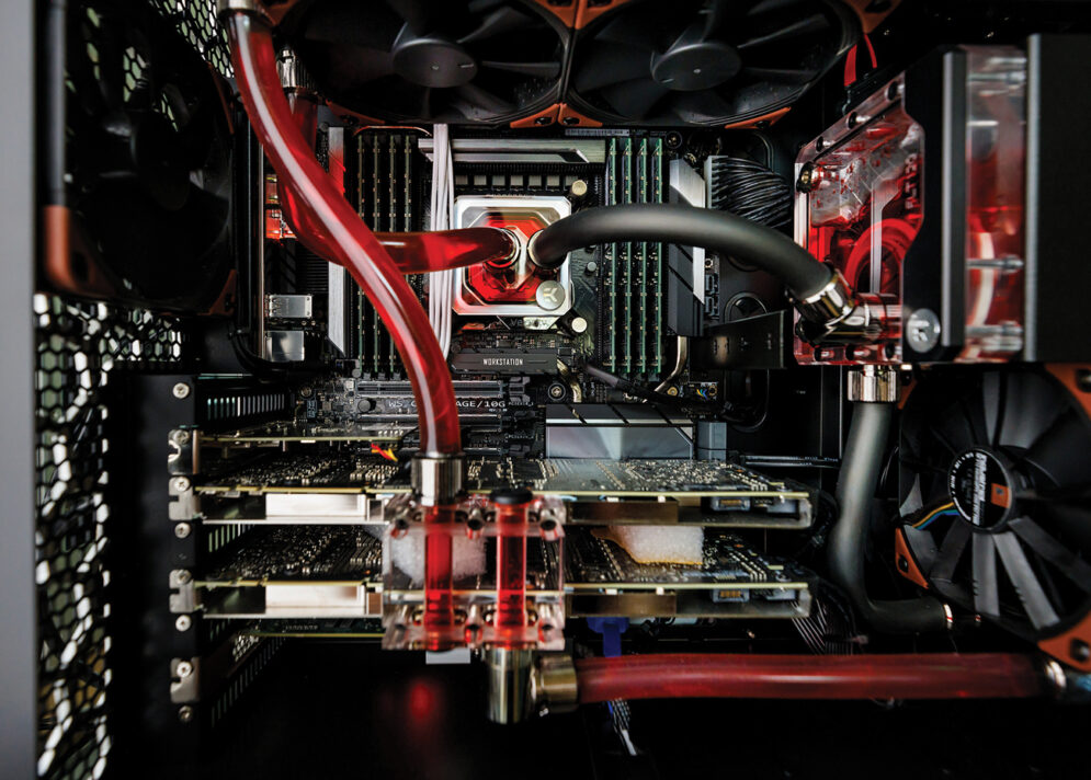 The inner workings, including glowing red components, of a computer station.