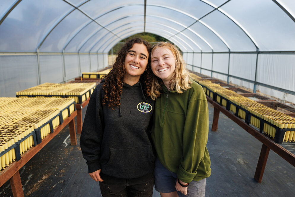 Two young women in a greenhouse
