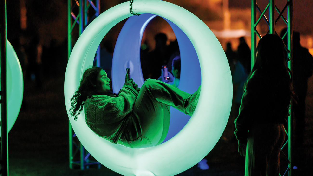 A student hangs in a green inflatable ring