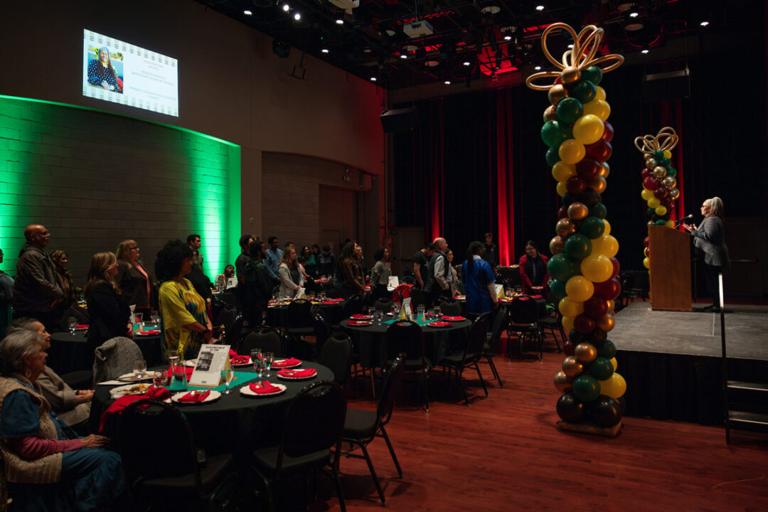 People sit at tables surrounded by colorful balloons at Cal Poly's MLK Legacy event in 2024.