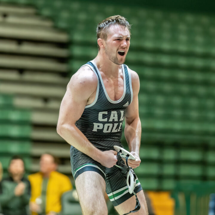 Brawley Lamer in a green singlet celebrates after a match