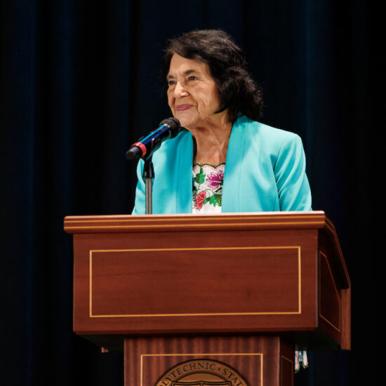 Dolores Huerta speaks at a podium