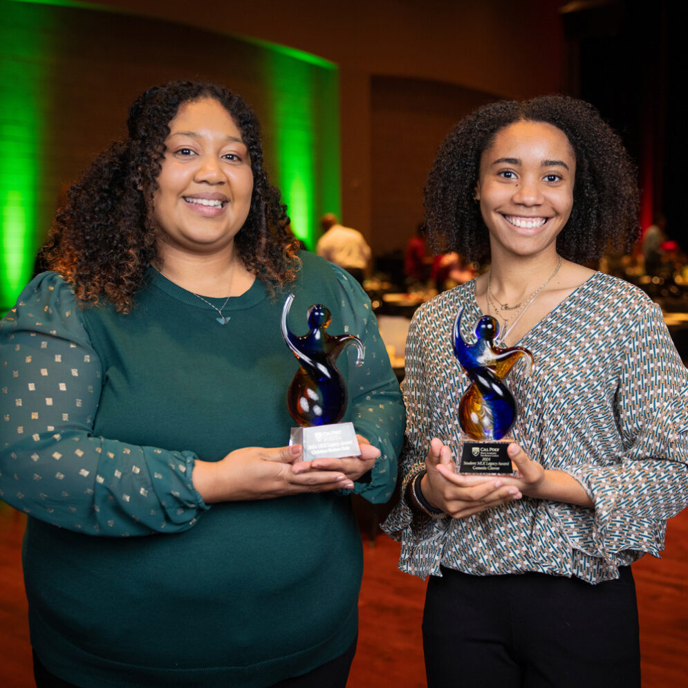 Christina Scholars Ortiz and Genesis Glover hold glass awards