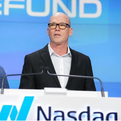 Michael Willis stands at a podium near the NASDAQ logo