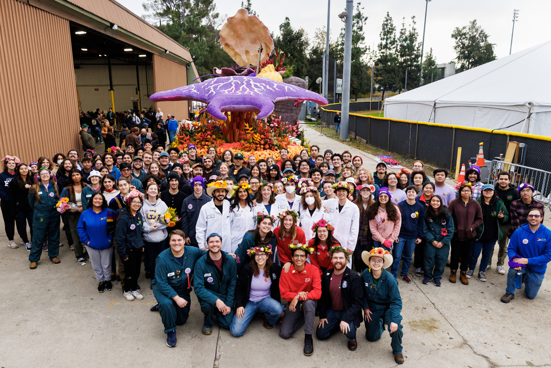 Dozens of people stand in front of the 2024 Cal Poly Rose Parade float