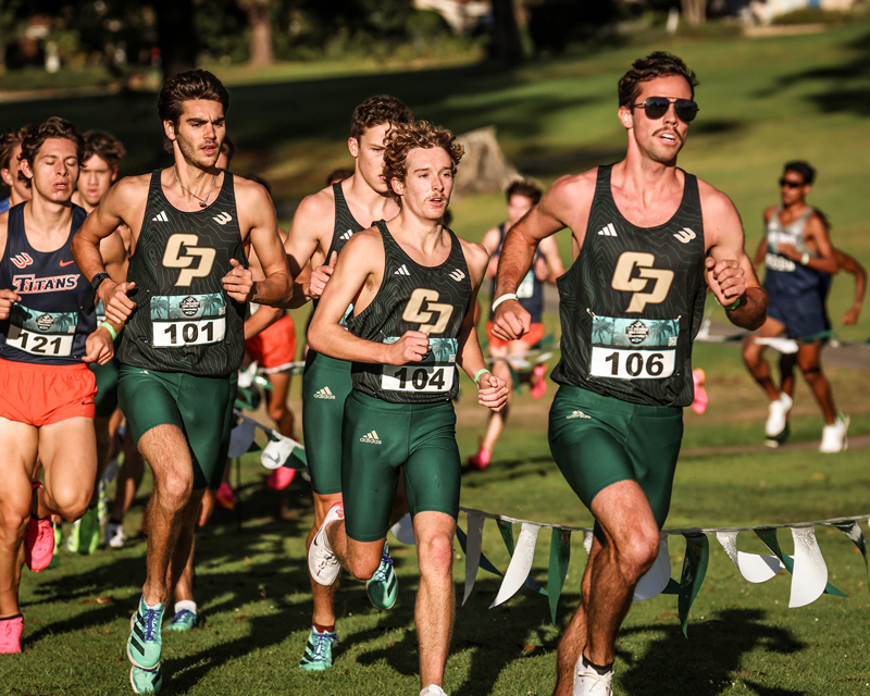 Members of Cal Poly's men's cross country team run past competitors during a conference meet