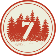 A circular icon featuring trees and the number seven